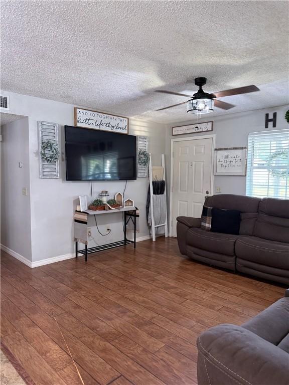 604 W Carver St, Ozark, AR 72949 - living area featuring ceiling fan, wood-type flooring, and a textured ceiling
