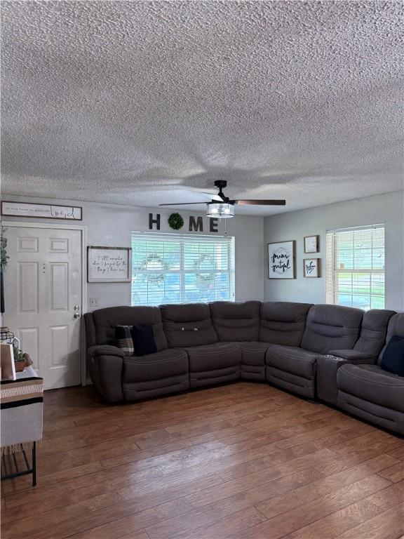 604 W Carver St, Ozark, AR 72949 - living room featuring a ceiling fan, a textured ceiling, and wood finished floors