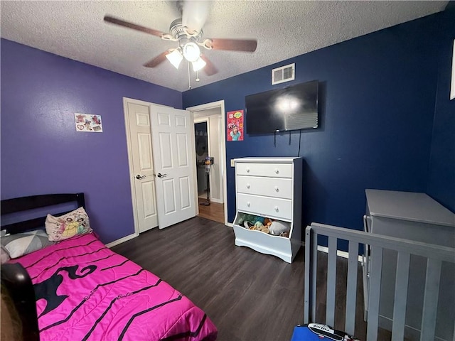 604 W Carver St, Ozark, AR 72949 - bedroom with dark wood finished floors, a textured ceiling, and ceiling fan