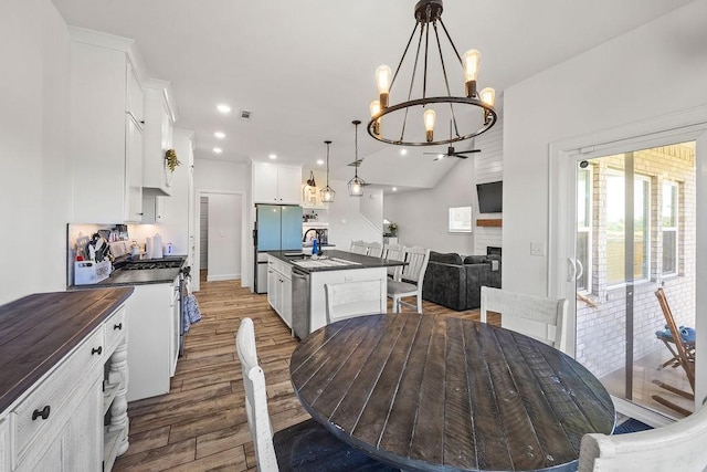 1251 Bootleg Rd, Centerton, AR 72719 - dining room featuring a chandelier, wood finished floors, and recessed lighting