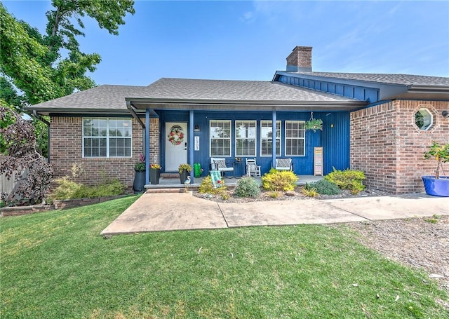 1303 W Pine St, Rogers, AR 72758 - view of front facade with a front lawn, a porch, brick siding, a chimney, and a shingled roof