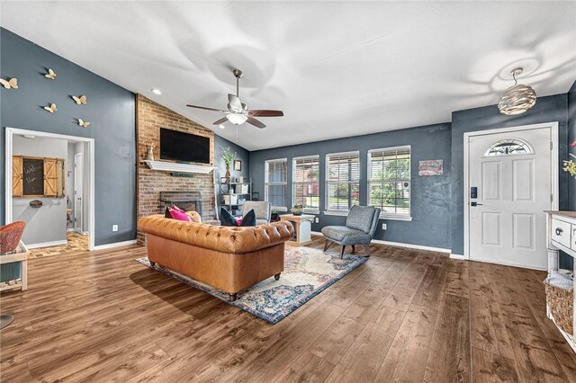 1303 W Pine St, Rogers, AR 72758 - living area with a fireplace, lofted ceiling, wood finished floors, and a ceiling fan
