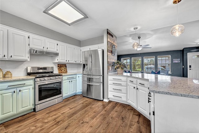 1303 W Pine St, Rogers, AR 72758 - kitchen with appliances with stainless steel finishes, under cabinet range hood, wood finished floors, a peninsula, and white cabinetry