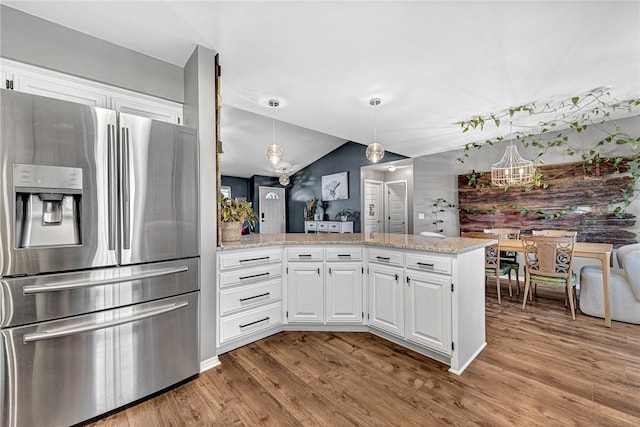 1303 W Pine St, Rogers, AR 72758 - kitchen featuring stainless steel refrigerator with ice dispenser, a peninsula, wood finished floors, white cabinetry, and vaulted ceiling