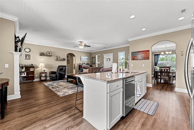 477 Caballo St, Farmington, AR 72730 - kitchen featuring stainless steel dishwasher, arched walkways, a chandelier, a kitchen island with sink, and white cabinets