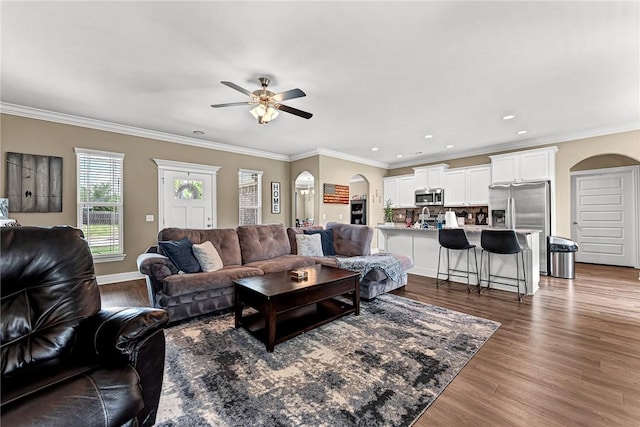 477 Caballo St, Farmington, AR 72730 - living room with arched walkways, a ceiling fan, wood finished floors, crown molding, and recessed lighting