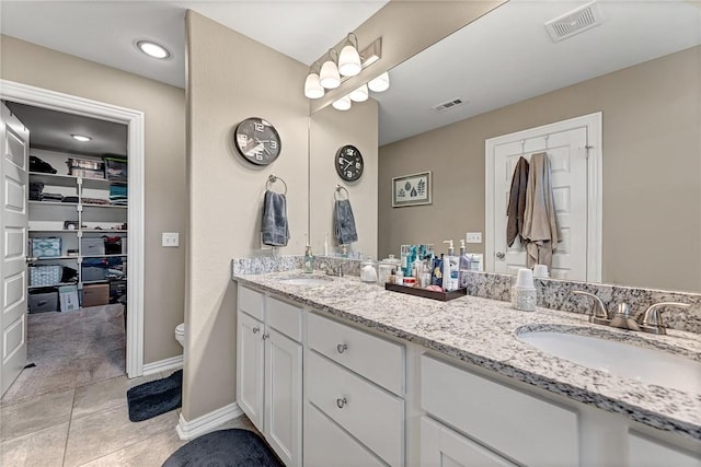 477 Caballo St, Farmington, AR 72730 - bathroom featuring double vanity, a spacious closet, and tile patterned floors