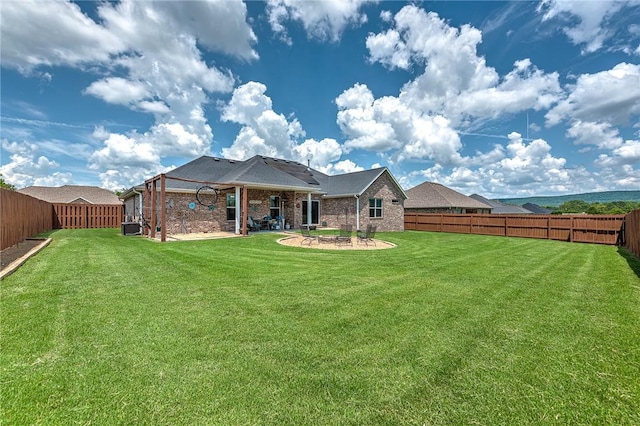 477 Caballo St, Farmington, AR 72730 - back of house with a fenced backyard, brick siding, and a patio area