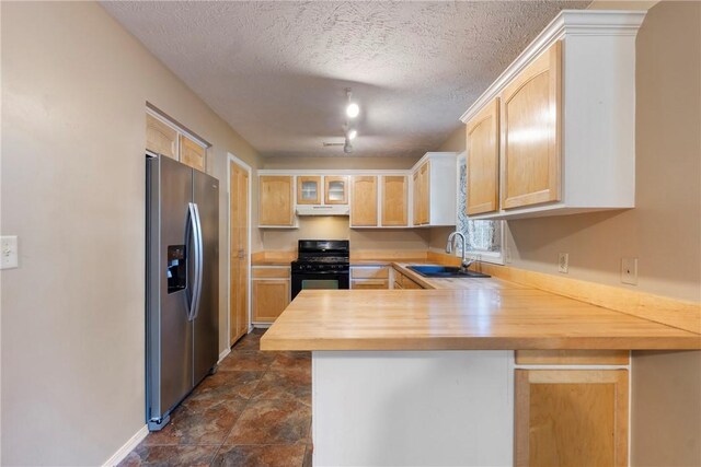 17 Pivot Rock Rd Unit 5, Eureka Springs, AR 72632 - kitchen featuring stainless steel refrigerator with ice dispenser, black gas stove, a peninsula, light brown cabinets, and wood counters