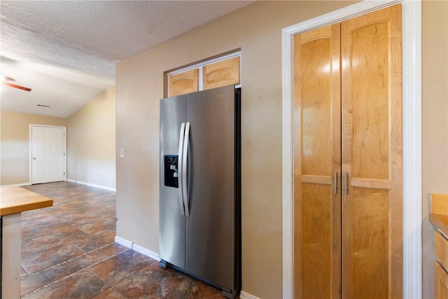 17 Pivot Rock Rd Unit 5, Eureka Springs, AR 72632 - kitchen with stainless steel fridge, dark stone finish floors, ceiling fan, and a textured ceiling