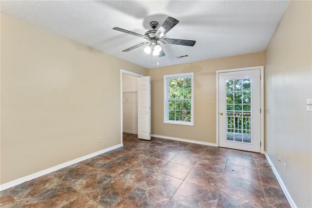 17 Pivot Rock Rd Unit 5, Eureka Springs, AR 72632 - unfurnished bedroom featuring access to outside, ceiling fan, a textured ceiling, and a walk in closet
