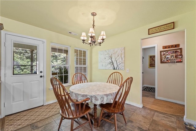 950 Nemett Cir, Pea Ridge, AR 72751 - dining room featuring a chandelier and stone finish floors
