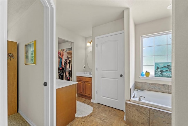 950 Nemett Cir, Pea Ridge, AR 72751 - bathroom with vanity, a bath, and a spacious closet