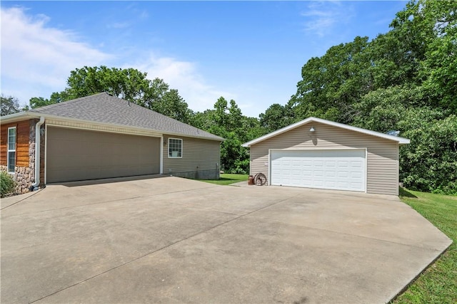 950 Nemett Cir, Pea Ridge, AR 72751 - view of side of property with a garage, an outdoor structure, and stone siding
