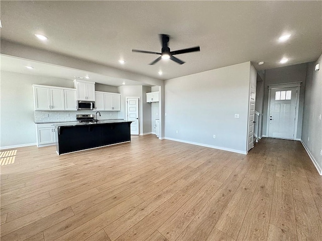 4807 SW Wakanda St, Bentonville, AR 72713 - kitchen featuring stainless steel appliances, a ceiling fan, light wood-type flooring, white cabinetry, and recessed lighting