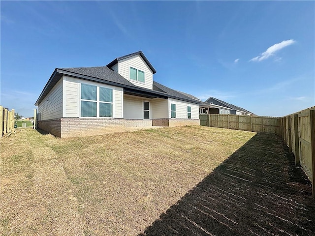 4807 SW Wakanda St, Bentonville, AR 72713 - back of property featuring brick siding and a fenced backyard