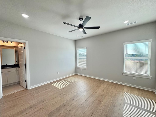 4807 SW Wakanda St, Bentonville, AR 72713 - unfurnished bedroom with light wood finished floors, recessed lighting, connected bathroom, and ceiling fan