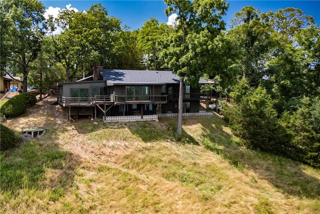 409 Hillcrest Rd, Eureka Springs, AR 72631 - back of property with a deck, a chimney, and a yard