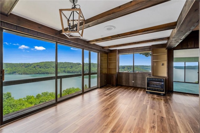 409 Hillcrest Rd, Eureka Springs, AR 72631 - unfurnished sunroom featuring a chandelier, heating unit, beamed ceiling, and a water view