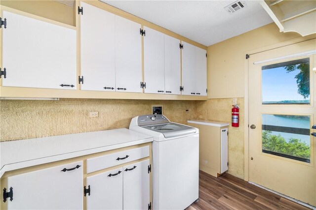 409 Hillcrest Rd, Eureka Springs, AR 72631 - laundry area with washer / clothes dryer, cabinet space, and dark wood-style floors
