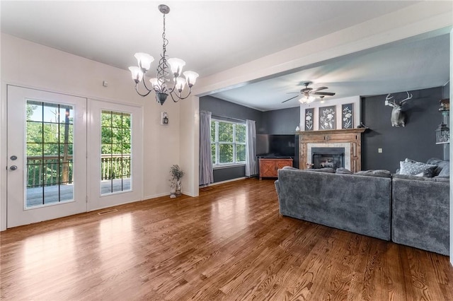 21 Cherhill Dr, Bella Vista, AR 72714 - living room featuring wood finished floors, a glass covered fireplace, a chandelier, and a ceiling fan