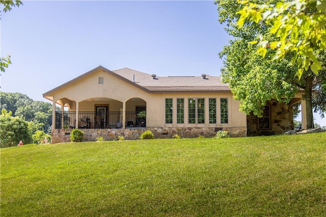 21569 Sibley Rd, Sulphur Springs, AR 72768 - back of property with stone siding, a lawn, and stucco siding