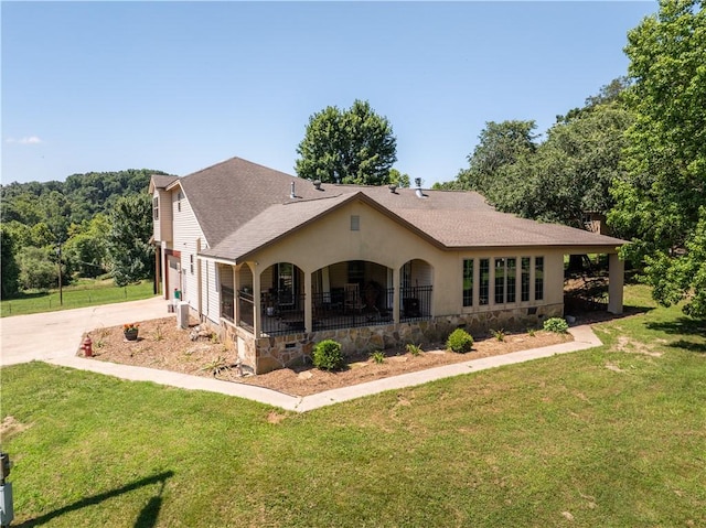 21569 Sibley Rd, Sulphur Springs, AR 72768 - rear view of house featuring concrete driveway, a lawn, a garage, and a shingled roof