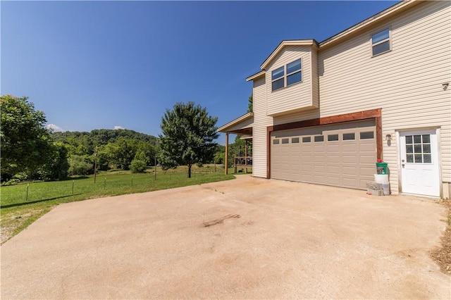 21569 Sibley Rd, Sulphur Springs, AR 72768 - view of property exterior with driveway and a garage