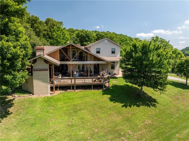 21569 Sibley Rd, Sulphur Springs, AR 72768 - back of house with a yard, a balcony, a deck, a chimney, and a wooded view