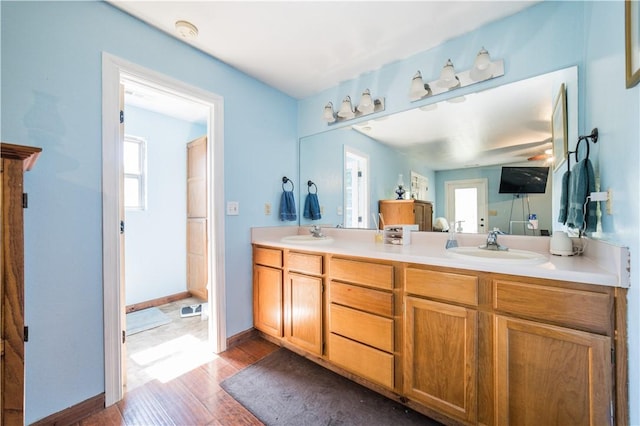 21569 Sibley Rd, Sulphur Springs, AR 72768 - bathroom with double vanity and wood finished floors