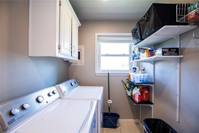 704 NW 8th St, Bentonville, AR 72712 - washroom with washing machine and dryer, cabinet space, and light tile patterned flooring