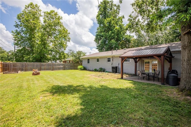 704 NW 8th St, Bentonville, AR 72712 - fenced backyard featuring a patio area, an outdoor fire pit, and french doors
