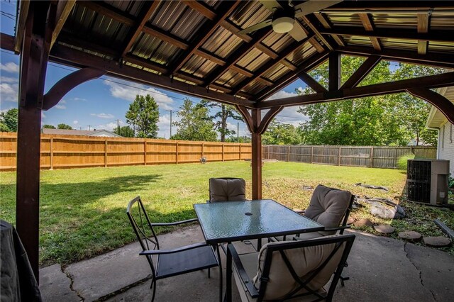 704 NW 8th St, Bentonville, AR 72712 - fenced backyard with ceiling fan, a patio, and outdoor dining space