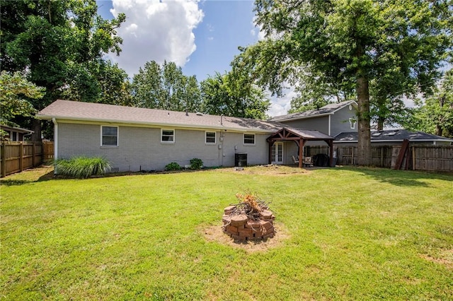704 NW 8th St, Bentonville, AR 72712 - rear view of house featuring an outdoor fire pit, a fenced backyard, and brick siding