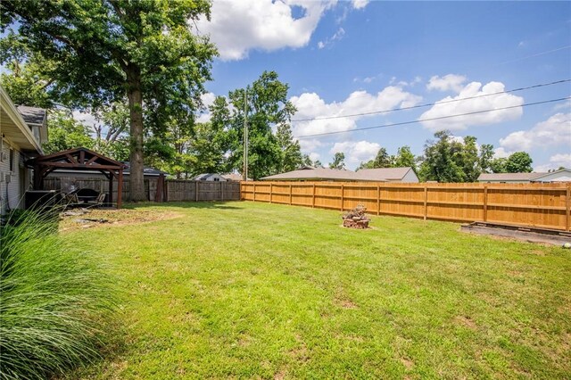 704 NW 8th St, Bentonville, AR 72712 - fenced backyard featuring a gazebo and a fire pit