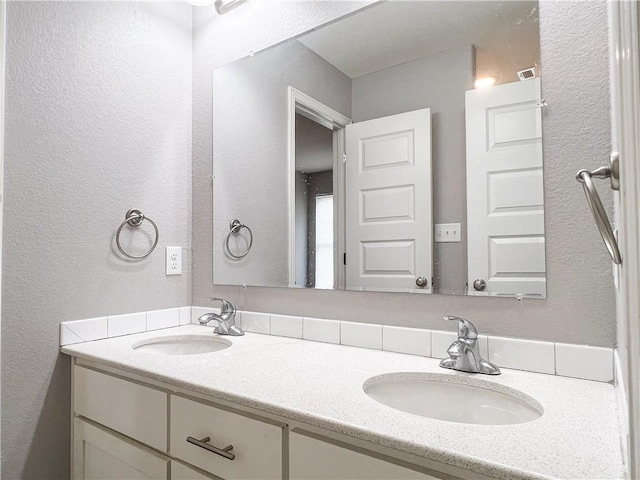 4082 W Sardinia Way, Fayetteville, AR 72704 - bathroom with double vanity and a textured wall