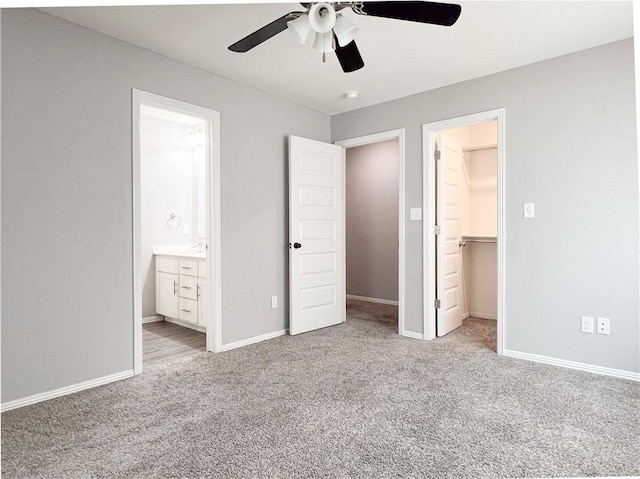 4082 W Sardinia Way, Fayetteville, AR 72704 - unfurnished bedroom featuring a spacious closet, carpet, a closet, connected bathroom, and a ceiling fan