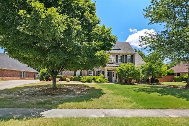 1754 N Hartford Dr, Fayetteville, AR 72701 - view of front facade with concrete driveway, brick siding, and solar panels