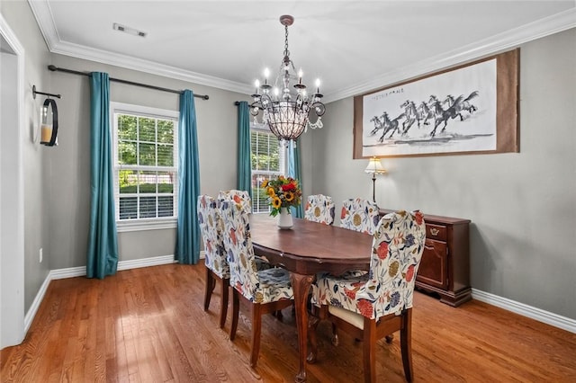1754 N Hartford Dr, Fayetteville, AR 72701 - dining space featuring a chandelier, light wood-style floors, and ornamental molding