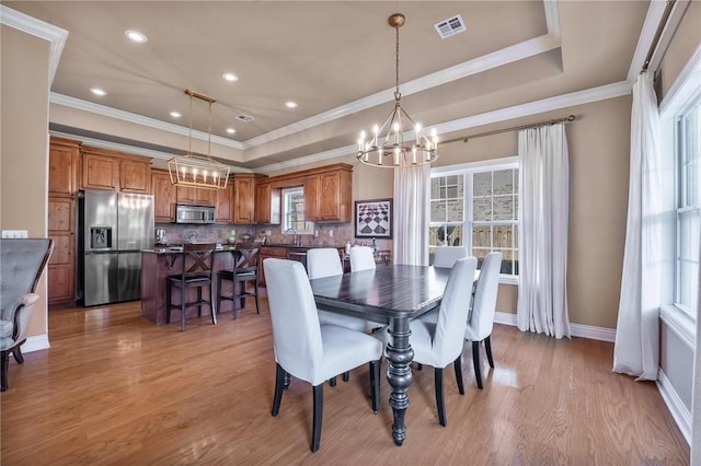 1531 Partridge Run, Bentonville, AR 72713 - dining area featuring a tray ceiling, a chandelier, light wood-style floors, and ornamental molding