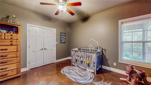 19641 Conestoga Rd, Elkins, AR 72727 - bedroom featuring concrete flooring, a ceiling fan, and a closet
