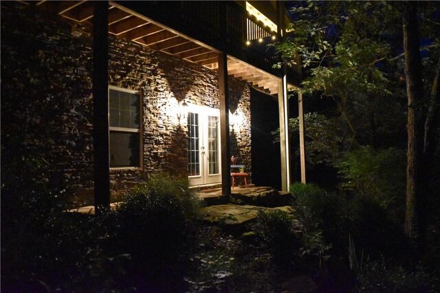 19641 Conestoga Rd, Elkins, AR 72727 - property exterior at twilight with french doors and stone siding