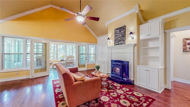 19641 Conestoga Rd, Elkins, AR 72727 - living room with a wood stove, ceiling fan, dark wood-style flooring, and high vaulted ceiling