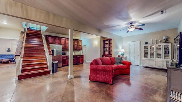 19641 Conestoga Rd, Elkins, AR 72727 - living room featuring a ceiling fan, concrete flooring, and stairway
