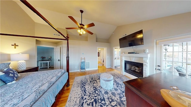 8271 S Lakeshore Dr, Rogers, AR 72756 - bedroom with lofted ceiling, wood finished floors, and a fireplace