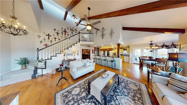 8271 S Lakeshore Dr, Rogers, AR 72756 - living room featuring a chandelier, ceiling fan, stairway, beam ceiling, and wood finished floors