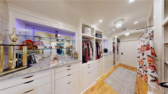 8271 S Lakeshore Dr, Rogers, AR 72756 - spacious closet featuring light wood-style flooring and vaulted ceiling
