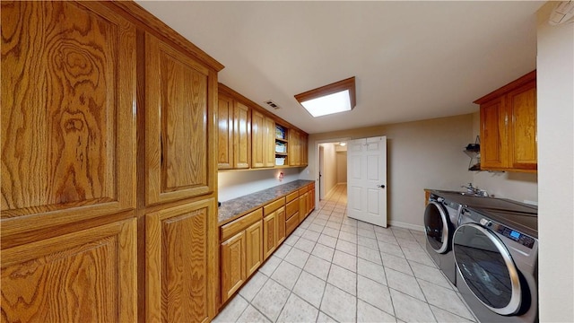 8271 S Lakeshore Dr, Rogers, AR 72756 - laundry area with cabinet space, washing machine and dryer, and light tile patterned flooring