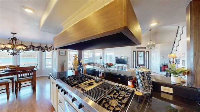 8271 S Lakeshore Dr, Rogers, AR 72756 - kitchen featuring a chandelier, a textured ceiling, premium range hood, hanging light fixtures, and recessed lighting