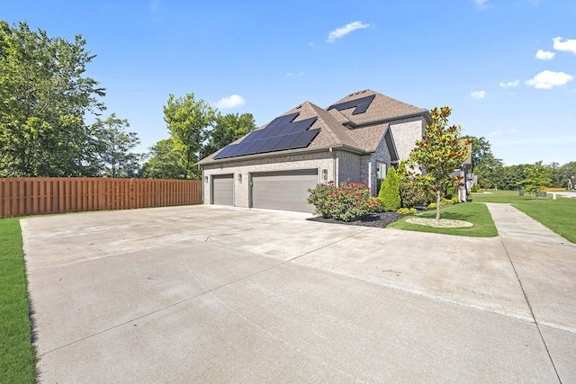 1575 Lake Estates Dr, Springdale, AR 72762 - view of side of property with roof mounted solar panels, driveway, an attached garage, brick siding, and roof with shingles